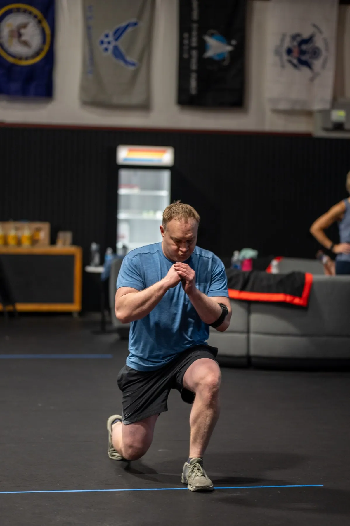 A member lunging with a dumbbell