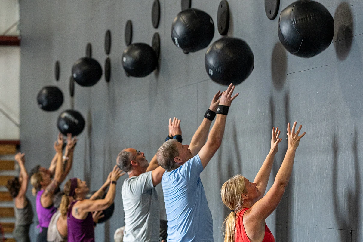 A class throwing wall balls side by side